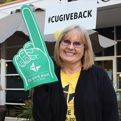 Volunteers help with a Give Back T-shirt table